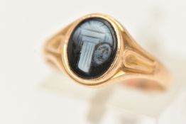 A YELLOW METAL SARDONYX RING, of an oval form with a black and white sardonyx cameo, collet set to