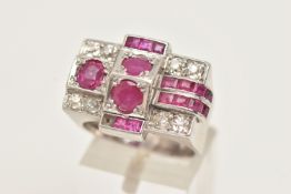 A MID CENTURY RUBY AND DIAMOND RING, a white metal retro design ring set with one oval cut, two
