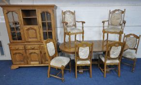 A LATE 20TH CENTURY OAK EIGHT PIECE LOUNGE SUITE, comprising an oval extending table, with a