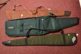A GUNLUGGA GREEN CANVAS AIR RIFLE CARRYING CASE, and two other air rifle carrying cases (3)