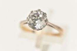 A YELLOW AND WHITE METAL GEM SET RING, set with a circular cut colourless paste, claw set in a white