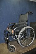 A SOMA AGILE FOLDING WHEELCHAIR with two footrests