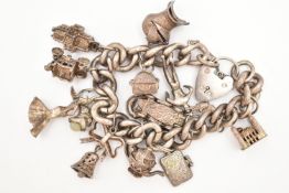 A SILVER CHARM BRACELET, a large curb link chain bracelet, fitted with a heart padlock clasp,