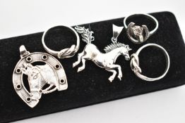 FIVE WHITE METAL JEWELLERY ITEMS, to include a horse shoe and head pendant, a running horse pendant,