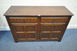 A 20TH CENTURY OAK SIDEBOARD, with two drawers, above double cupboard doors, width 125cm x depth