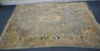 A LARGE RECTANGULAR CHINESE WOOLLEN RUG, 282cm x 180cm (condition report: has a few tassels