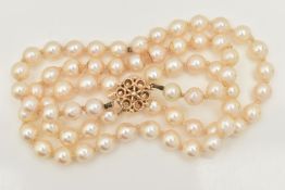 A SINGLE STRAND OF CULTURED PEARLS, row of cream pearls with pink hues, individually knotted on a