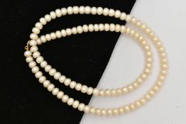 A CULTURED FRESH WATER PEARL NECKLACE, a single strand necklace, fitted with a yellow metal clasp,