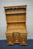 A 20TH CENTURY PINE DRESSER, the three tier plate rack with three drawers, atop a base with three
