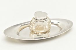 AN EDWARD VII INKWELL, a small glass inkwell with a plain polished hinged silver lid, together