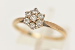A 9CT GOLD DIAMOND CLUSTER RING, flower shape cluster set with seven round brilliant cut diamonds,