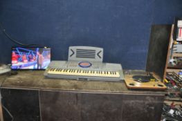 A SAMSUNG LT24D390S 24in TV (no remote), a Panasonic electronic keyboard, folding stand and an Ion
