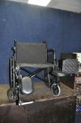 A WIDE HEAVY DUTY FOLDING WHEELCHAIR width of seat 61cm, with two adjustable footrests with calf