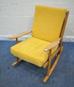 A MID CENTURY ELM ROCKING CHAIR, with yellow upholstered cushions, width 65cm x depth 86cm x