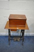 A WILLCOX AND GIBBS AUTOMATIC TREADLE SEWING MACHINE, with a mahogany case, raised on a wrought iron