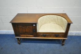 A LATE 20TH CENTURY OAK TELEPHONE SEAT, with foliate upholstery, a single linenfold door, and a