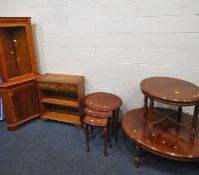 AN OVAL COFFEE TABLE, a matching occasional table, a nest of three tables, a bookcase with two