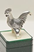 A LARGE WHITE METAL RING, designed as a chicken, leading on to a tapered shank, approximate height