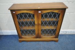 A LATE 20TH CENTURY OAK BOOKCASE, with double lead glazed doors, width 93cm x depth 26cm x height
