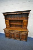 IN THE MANNER OF TITCHMARSH AND GOODWIN, AN 18TH CENTURY STYLE SOLID OAK DRESSER, the three tier