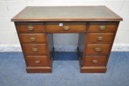A 20TH CENTURY MAHOGANY KNEEHOLE DESK, with a green leather writing surface, fitted with nine