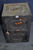 AN EARLY 20th CENTURY CAST IRON SAFE with panelled detail to the front, sides and top, enclosing two