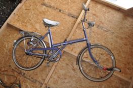A VINTAGE RALEIGH STOWAWAY FOLDING BIKE with 17in frame, front and rear dynamo lights, rear rack
