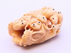 A bone carving in the form of bugs. 5 cm high.