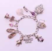 A silver charm bracelet. 19 cm long. 33.7 grammes total weight.