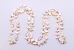 A 9 ct (tested) yellow and white gold necklace set with mother-of-pearl by Jane Sarginson, boxed.