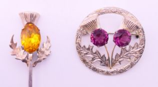 A pair of Sterling silver Scottish brooches. One 9 cm wide, the other 4 cm wide.