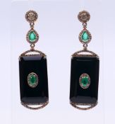 A pair of onyx, diamond and emerald earrings. 5.5 cm high.