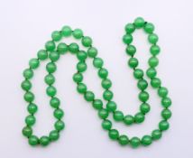 A string of jade beads. 82 cm long.