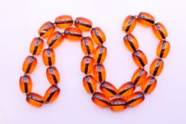 A string of beads. 80 cm long.