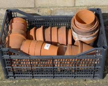 A quantity of terracotta flowerpots. The largest 11 cm high.