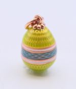 A 14 ct gold and enamel egg pendant bearing Russian marks. 2 cm high.