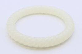 A white jade bangle. 6 cm internal diameter, 8.5 cm outer diameter.