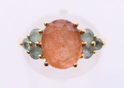 A 14 K topaz and tourmaline ring. Ring size N.