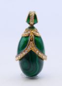 A malachite and enamel egg form pendant. 3.5 cm high.