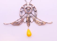 A silver Art Nouveau-style winged female head and bead pendant on a silver chain.
