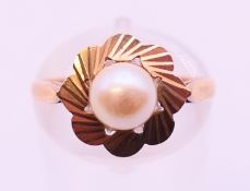 A 9 ct gold cultured pearl (6.2mm) single stone ring. Ring size M.