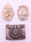 A WWII German belt buckle and two awards. Buckle 6.5 x 5 cm.