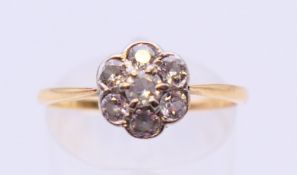 A transitional cut diamond seven stone cluster ring, estimated 0.40 ct, SI, tested gold 18 ct.