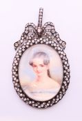 A 19th century portrait miniature on ivory of a lady a diamond set frame with bow tied swag and