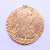 A 1787 gold Escudo coin. 1.75 cm diameter. 2.1 grammes.