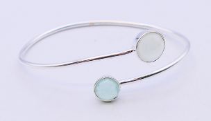 A silver quartz bangle.