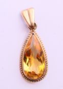 A 9 ct gold citrine pendant. 2.5 cm high.