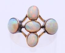 A 9 ct gold five stone opal ring. Ring size N.