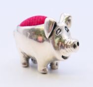 A silver pig pin cushion. 2 cm high.