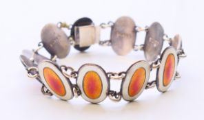 A silver and enamel bracelet. 18 cm long.